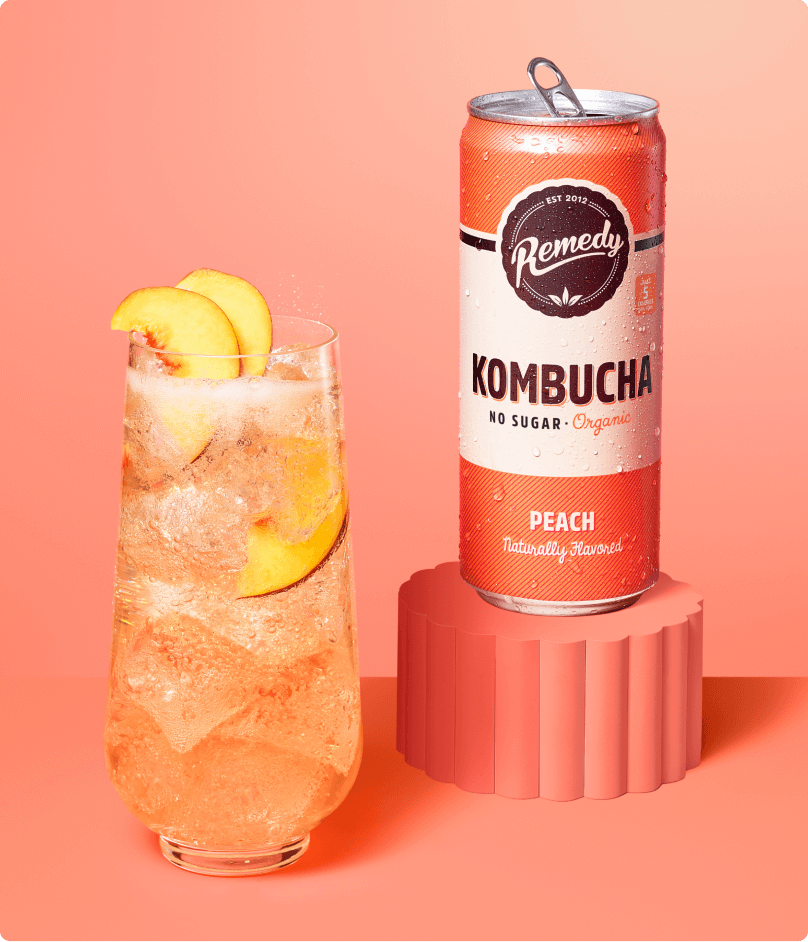 Remedy Kombucha Peach Can and Glass Lifestyle