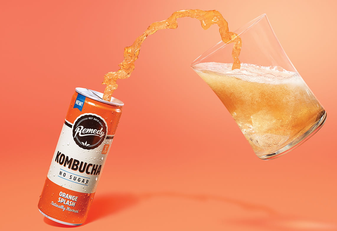 Remedy Kombucha Orange Splash can pouring into a glass
